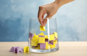 Woman,Taking,Paper,Piece,From,Glass,Vase,On,Table.,Lottery