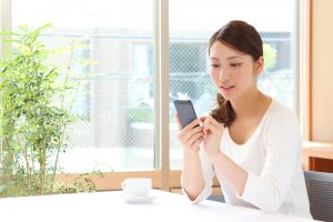Asian,Woman,Using,A,Smart,Phone