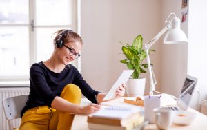 A,Young,Female,Student,Sitting,At,The,Table,,Using,Tablet