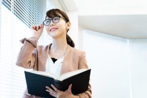 Portrait,Of,Asian,Woman,Holding,A,Book.