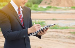 Businessman,Surveying,Land,For,Industrial,Project.selective,Focus,At,Hand.