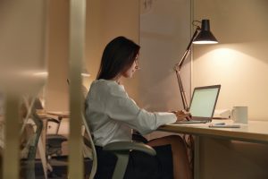 European,Businesswoman,Typing,On,Laptop,Computer,While,Sitting,On,Chair