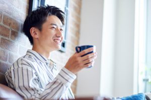 Young,Japanese,Man,Relaxing,In,The,Living,Room