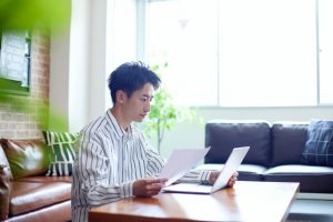 Young,Japanese,Man,Relaxing,In,The,Living,Room