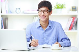 Happy,Young,Asian,Man,Looking,At,Camera,Smile,In,Home