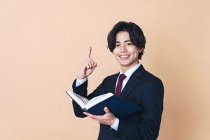 Young,Asian,Man,Holding,A,Book