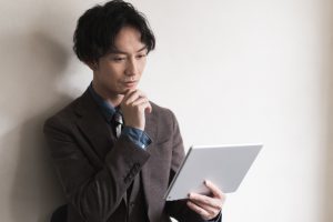Young,Businessman,Using,Digital,Tablet,While,Working.