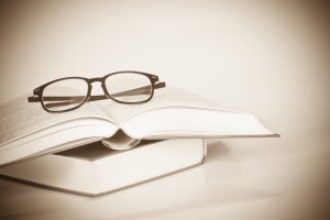 Black,Rimmed,Glasses,Placed,On,The,Opened,Book