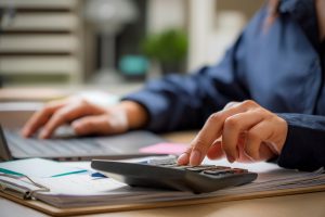 Asian,Woman,Calculating,Finance,,Money,,Using,Calculator,,Laptop,Computer,At