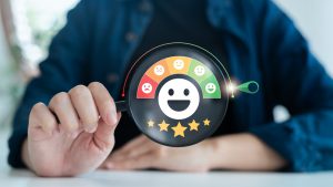 Close-up,Of,Hand,Holding,Rating,Dial,With,Smiley,Face,Feedback